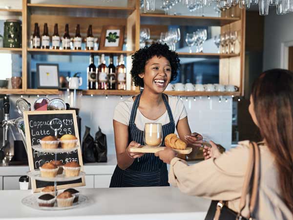 Restaurant owner giving a customer her order