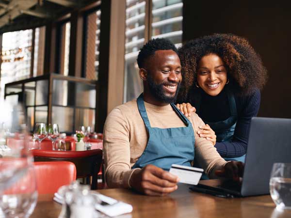 Two business owners making a payment online