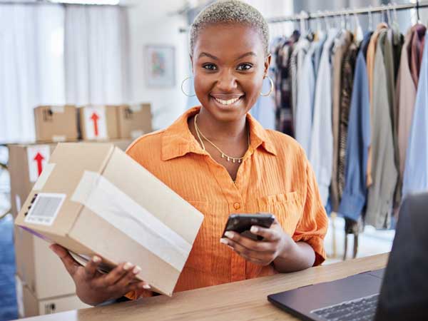 Woman at her desk about to send a package