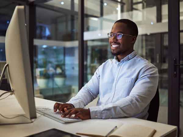 Business professional completing work on his desktop