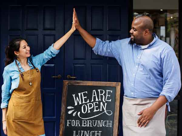 Two business owners giving high fives