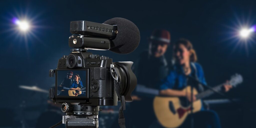 camera with microphone recording video blog of Musician duo band singing