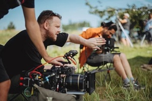 man shooting outdoors