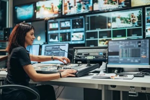 young beautiful woman working in a broadcast control room on a tv station