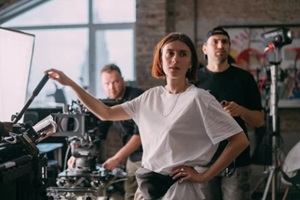 director of photography is a woman behind a video camera on the set