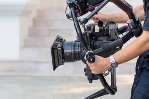 movie shooting or video production and film crew team with camera equipment