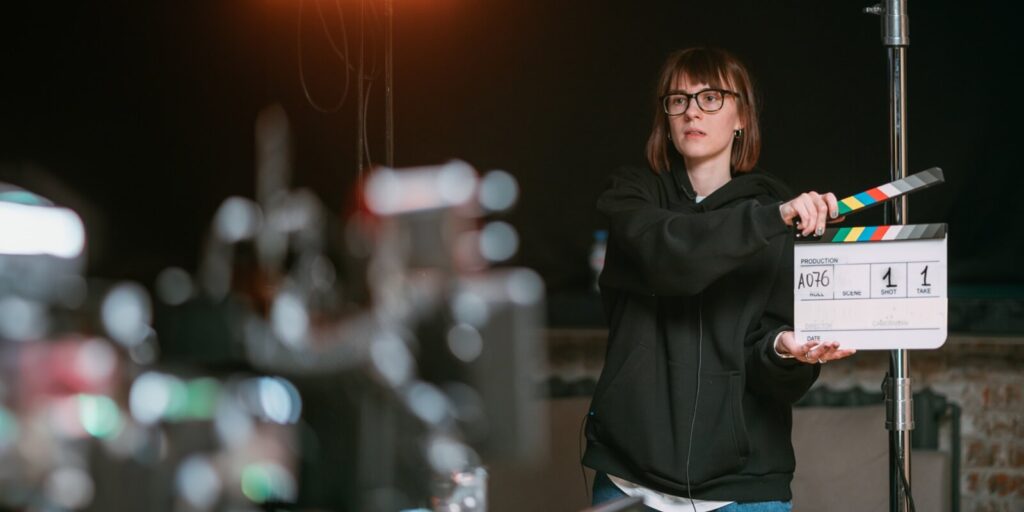 assistant director with clapperboard on set