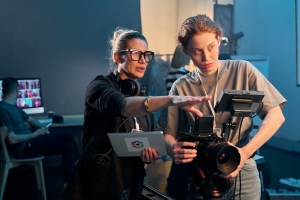 Female Director Giving Instructions to Camera Girl for Video Production