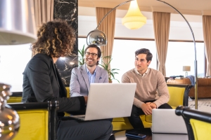 Agent Explaining DICE Insurance to Filmakers in A Hotel Room