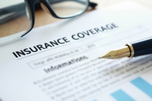 DICE Insurance Coverage Document with Pen and Glasses on Table