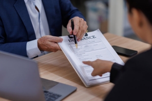 Agent Showing Place to Sign on Insurance Document to Cannabis Business Owner