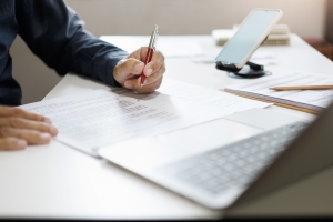 Film Producer Checking Types of Coverage in Insurance Policy