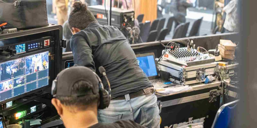 AV Production Team Operating Broadcast Monitors and Audio Mixer