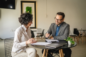 Event Planner Talking to Insurance Professional in a Cafe