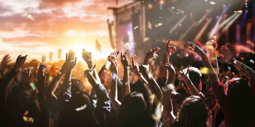 Large Crowd Dancing and Celebrating at Music Festival Stage